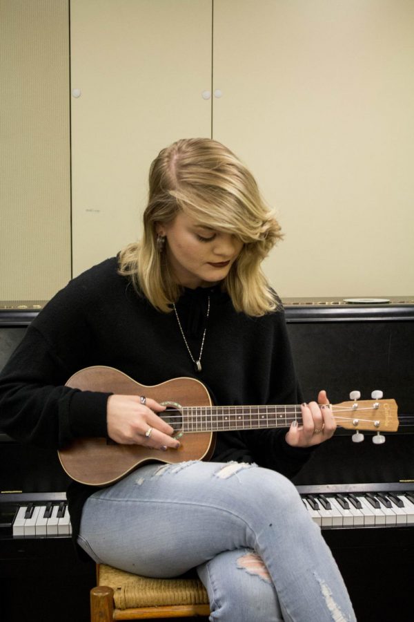 Corbett strums a uke... Check out her songs on Soundcloud.