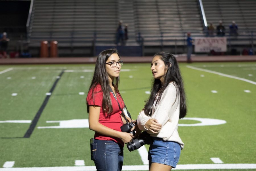 Senior Jesal Patel and junior Mya Tapia converse at the home game on October 20, 2017.