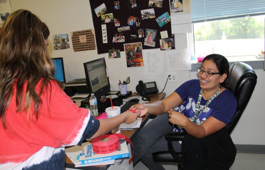 Ms. Delgado sells a ticket during a Peru trip meeting.