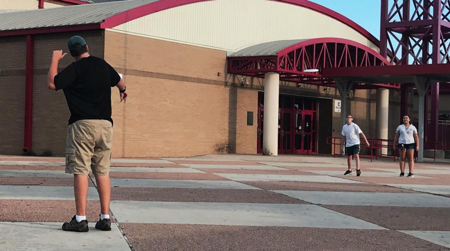 Students play frisbee in the Courtyard early in the morning.