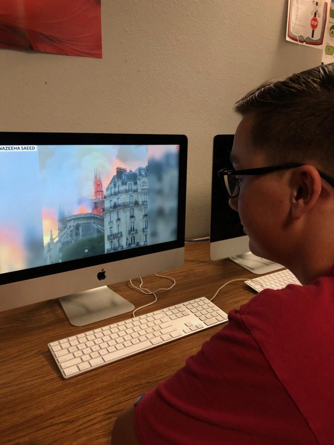 Nation sports editor Ethan Smith watches flames engulf the iconic Notre Dame Cathedral in Paris.