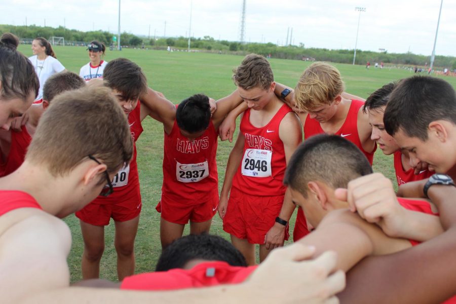 the jv boys do a prayer circle before the start of their race at the Chaps invitational 