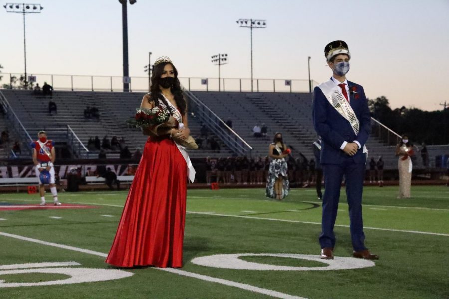 Homecoming queen Evelyn Martinez, 12, and Homecoming King Caiden Borrego, 12, face the roaring crowd at the homecoming football game against Lake Travis on Oct. 16. 