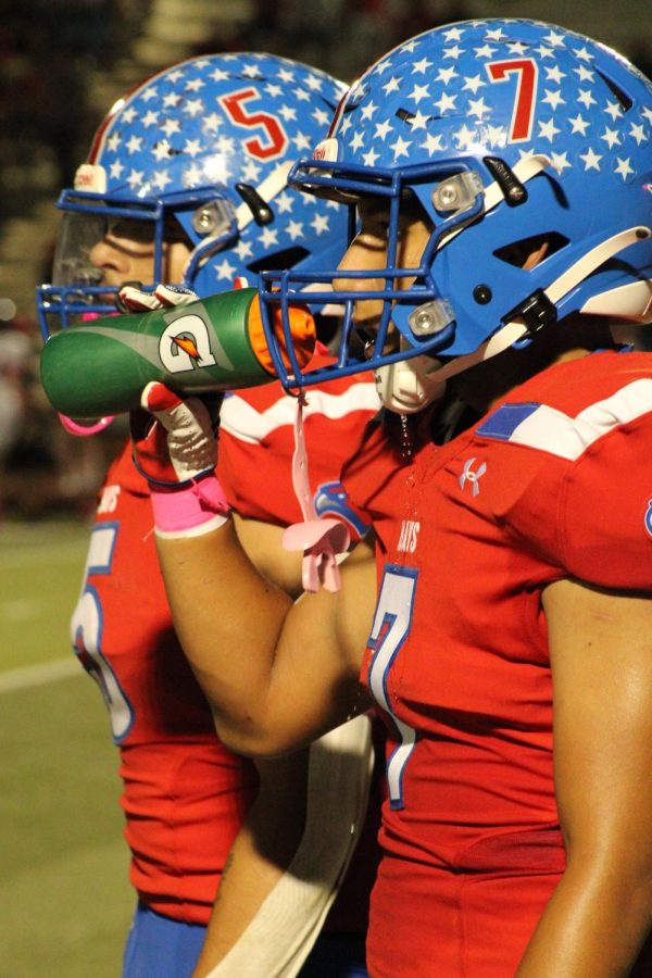 Jaime Hernandez, 12, takes a quick water break before getting back into the pink out game. 