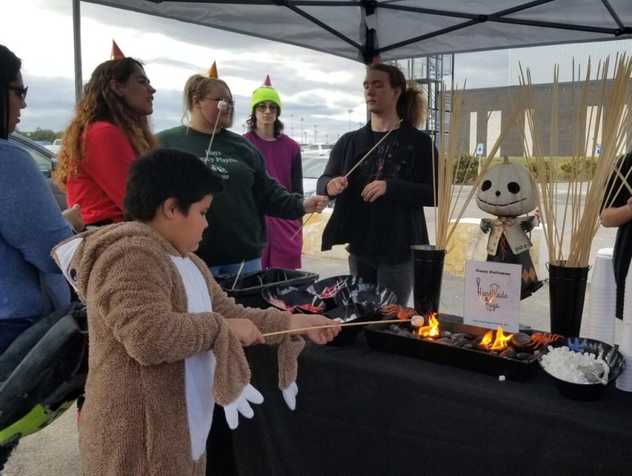 People roasting marshmallows at the culinary booth.