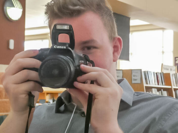 Sterling Johnson, 12, holding a camera at the recent Youth & Government conference.