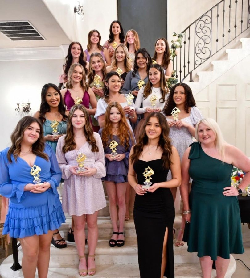 The Hays High School Cheer team Shows off their end of season trophies at the 2022-2023 cheer banquet.