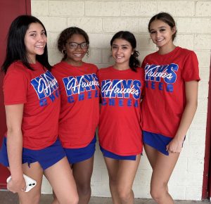 Varsity cheerleaders look forward to cheering on the Hawks.