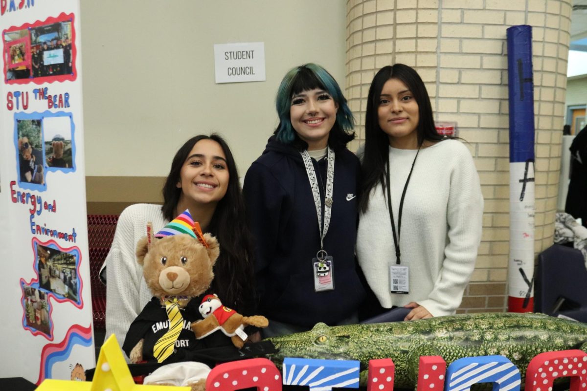Student Council members, Avery Auditore, Yaqueline Aguilera, and Charlie Bobadilla, sit behind the StuCo table as they greet eager new members.
